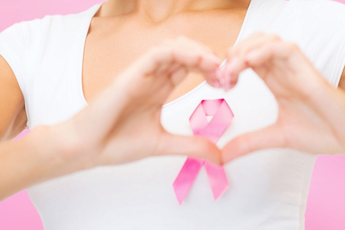 Woman holding a pink breast cancer awareness ribbon