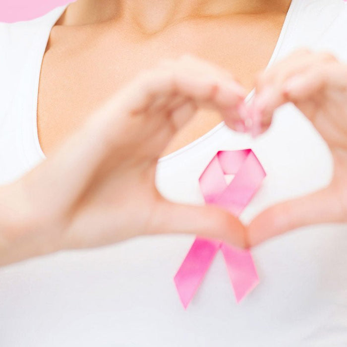 Woman holding a pink breast cancer awareness ribbon