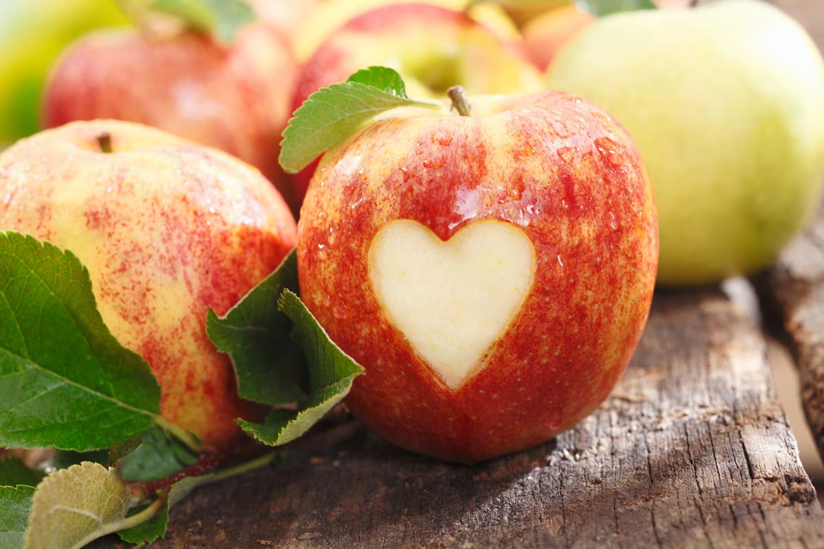 Red apples with a heart shape carved into one