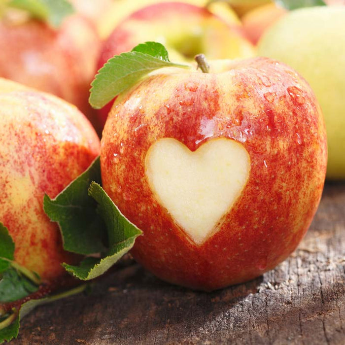 Red apples with a heart shape carved into one