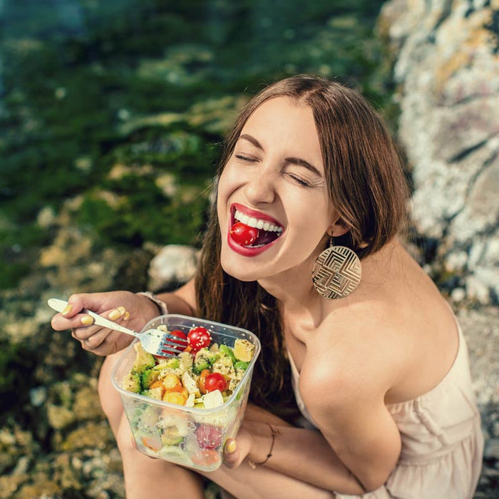 Woman eating a healthy salad outdoors